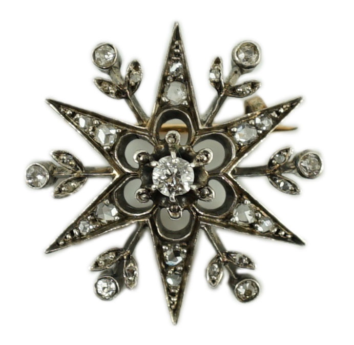 A Victorian gold, silver and diamond set starburst brooch